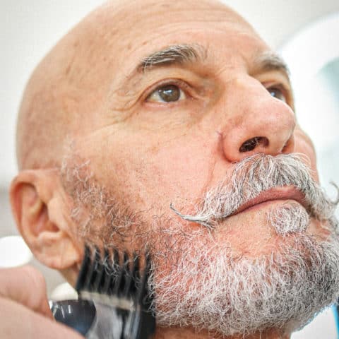 Men Getting Beard Trimmed At Hair Salon