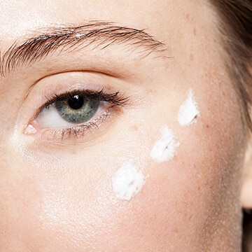 Closeup of a lady’s face with moisturizing cream